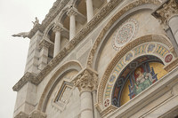 Detail of the tympanum and the north section of the main façade of the Pisa Cathedral - Pisa, Italy