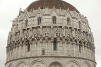 The loggia and Gothic details around the cupola of the baptistery of Pisa - Pisa, Italy
