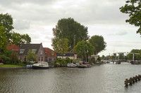 Vessels in the Vecht and houses of Weesp on the riverbank - Weesp, Netherlands