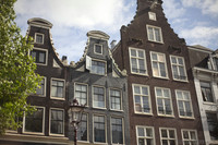 Façades of houses along the canals of Amsterdam - Amsterdam, Netherlands